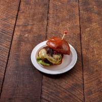 Nom Burger · All-natural beef patty, Gruyere, caramelized red onions, butter lettuce and roasted tomato a...