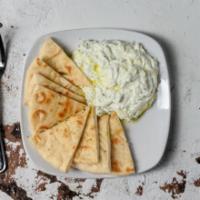 Tzatziki served with warm pita · Greek Yogurt with Cucumber, Garlic & Aromatic Dill; Served with Warm Pita.