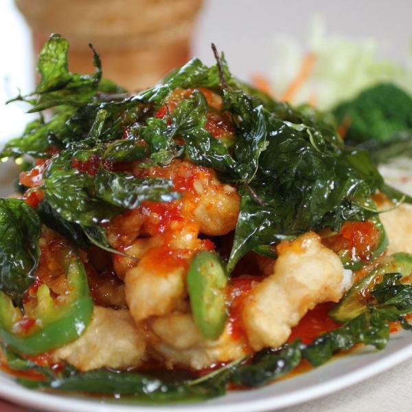 Sweet and Spicy Fish · This is a fish fillet, fried until crispy and then covered with a sweet spicy sauce made from garlic, palm sugar and chili. Topped off with crispy basil. Spicy.