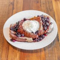 Lemon Blueberry French Toast · Thick sweet brioche, lemon cream, blueberry drizzle and whipped creme.