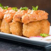 A12. Spicy Tuna Volcano · Spicy tuna tartare on top of deep fried sushi rice drizzled with wasabi tare sauce.