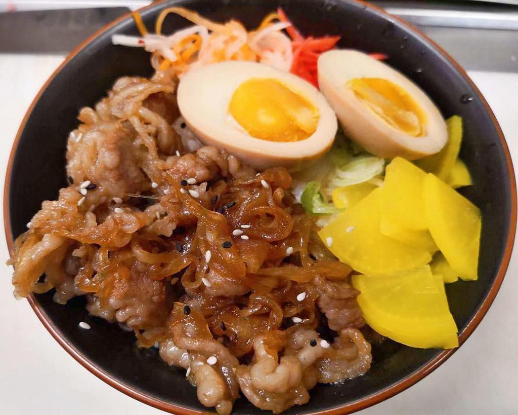 R1. Gyudon · Simmered toro beef and onion with house sweet soy sauce served over steamed rice with a side of pickles.