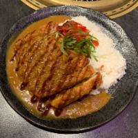 R4. Chicken Katsu Curry ·  House Japanese curry mix served over crispy chicken katsu, steamed rice, red pickled radish...