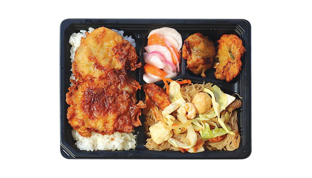 Breaded Pork Chop Bento Bx · Served with Pancit Bihon, Fish Fritters, Pickled Radish, and Rice.