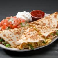 Breakfast Quesadilla Breakfast Special · A cheese quesadilla grilled golden brown and stuffed with scrambled eggs, ham, onion and gre...