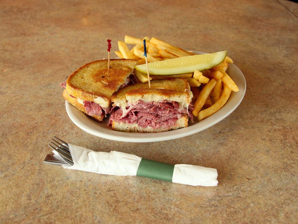 Dinty Moore Sandwich · A classic triple-decker. Corned beef, Swiss cheese, cole slaw and Thousand Island dressing on toasted rye.