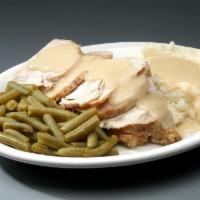 Fresh Oven Roasted Turkey · Slow roasted, hand carved turkey breast over stuffing topped with gravy and served with mash...