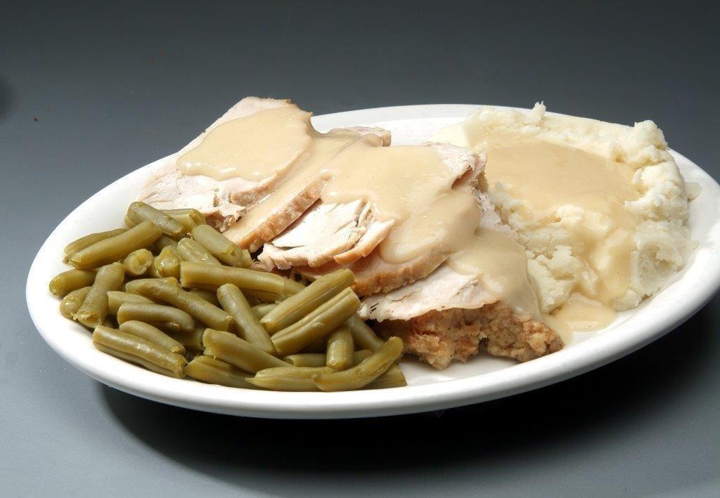 Fresh Oven Roasted Turkey · Slow roasted, hand carved turkey breast over stuffing topped with gravy and served with mashed potatoes and vegetables.