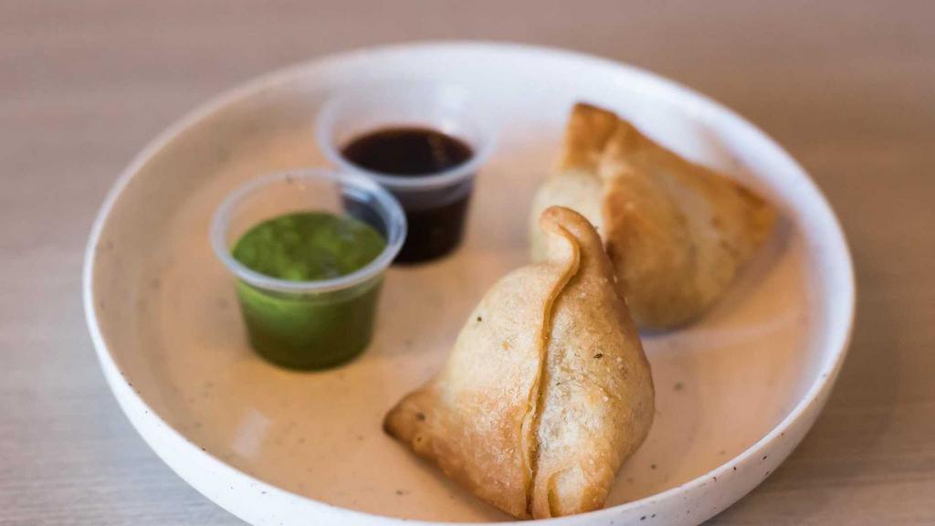 Mini Samosas · two savory puffed pastries stuffed with spiced potatoes and green peas. served with tamarind + mint cilantro chutney.
[contains gluten] [vegan upon request]