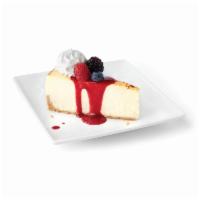 Creme Brulee Cheesecake · Decadent cheesecake, topped with raspberry coulis, mixed berries and whipped cream.
