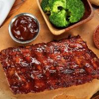 Baby Back Rib · Slow roasted and flame grilled, Jack Daniel's BBQ sauce, served with choice of 2 sides.