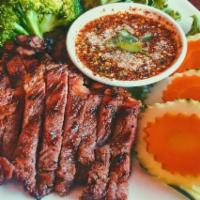 43. Crying Tiger Steak · Charbroiled marinated New York steak served with sweet and spicy lime sauce. Spicy.