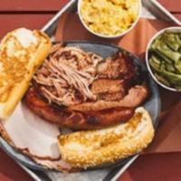 City Sampler with 2 Individual Sides · Brisket, pulled pork, sausage, turkey, two pint sides, Texas toast. (Feeds 1–2)