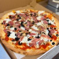 Capricciosa Pizza · Chunks of tomato, black olives, fresh mozzarella, prosciutto, and mushrooms.