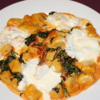 Gnocchi Padrino Dinner · Spinach and tomato in a cherry pink cream sauce topped with fresh mozzarella. Served with ch...