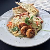Jambalaya Pasta · Penne pasta tossed in a spicy Cajun cream sauce with red and green bell peppers, andouille s...