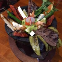Molcajete del Rancho · Mixed grilled chicken, shrimp, chorizo, churrasco with cactus, hot peppers, queso fresco and...