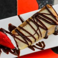 Cheesecake · Fried. Cheesecake drizzled with chocolate, caramel and whipped cream. Garnished with fresh s...