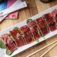 Tuna Tataki · Red tuna lightly seared, sliced, drizzled with sweet
chili, ponzu and eel sauces and finishe...