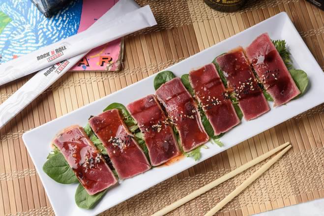 Tuna Tataki · Red tuna lightly seared, sliced, drizzled with sweet
chili, ponzu and eel sauces and finished with a sprinkle of sesame seeds.
A rare treat.