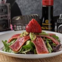Ahi Tuna Salad · Seared red tuna, cucumbers, strawberries and avocado served on a bed of spring mix. Glazed w...