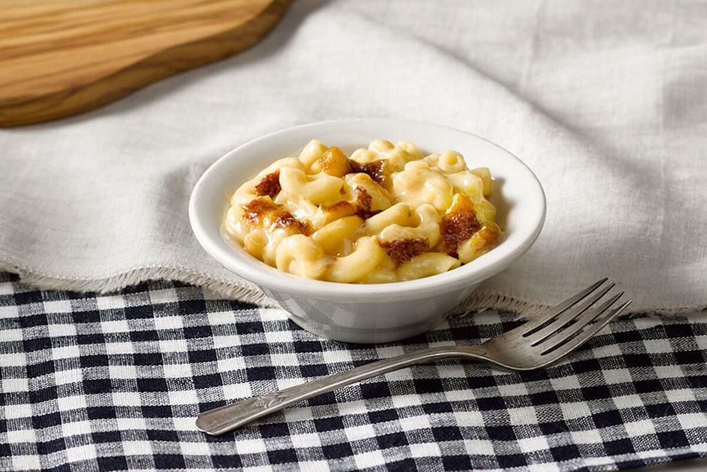Macaroni n' Cheese · Elbow Macaroni Noodles mixed with cheese and baked in the oven for our signature Macaroni n' Cheese.


