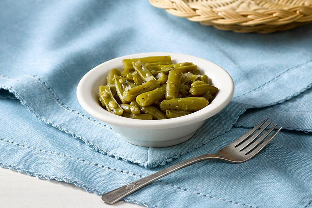 Green Beans · Greens Beans slow simmered with a hint of pork seasoning.

