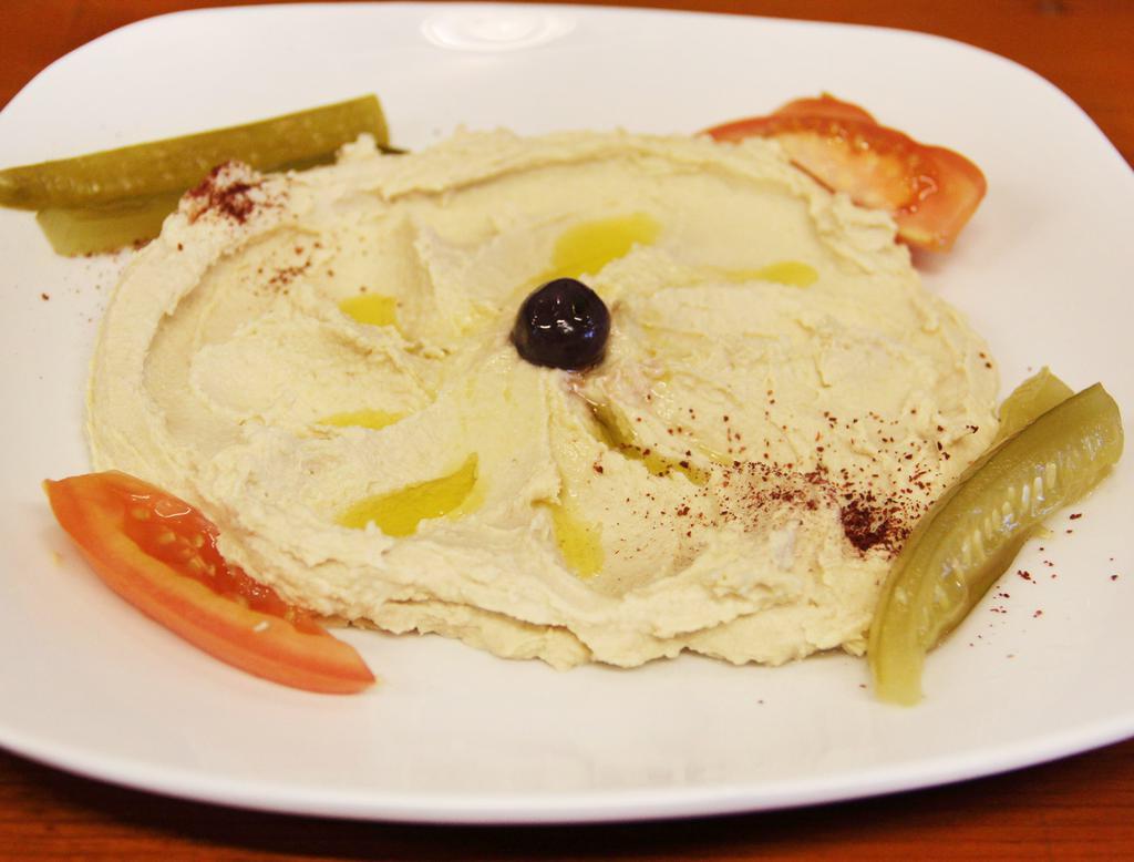 Hummus · Blend of garbanzo beans, garlic, lemon juice, tahini and olive oil. Served with choice of fresh pita bread.