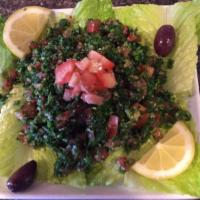 Tabbouleh Salad · Chopped parsley, tomatoes, onions, mint and bulgur wheat mixed with lemon juice and olive oil.