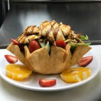 Asian Salad · Grilled chicken over tossed salad with oranges, strawberries, topped with fried noodles and ...