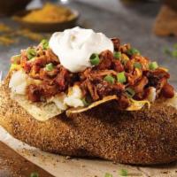 Brisket Chili Baker. · A giant smoked baker with margarine, sour cream, shredded cheddar cheese, green onions, and ...