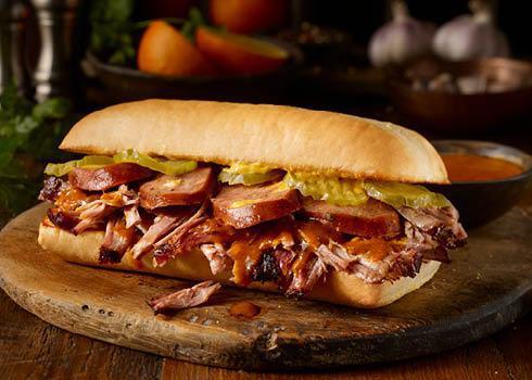 Cueban Sandwich · Citrus Pulled Pork, Jalapeno Cheddar Kielbasa with mustard & pickles on a toasted hoagie.