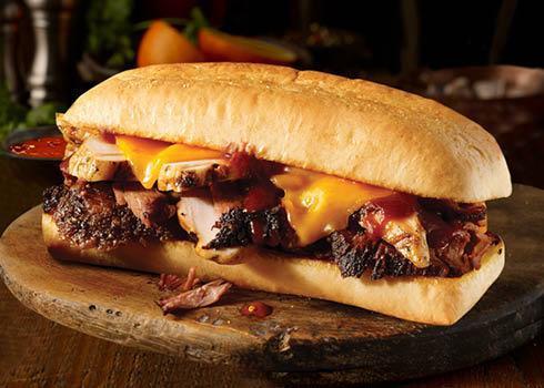 Westerner Sandwich · Texas sized sandwich, with your choice of two slow-smoked meats and cheddar cheese on a toasted hoagie bun.