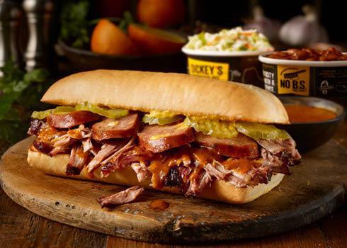 Cueban Sandwich Plate · Pulled pork with lemon pepper, jalapeño cheddar sausage, mustard & pickles on a toasted hoagie bun, served with 2 sides.