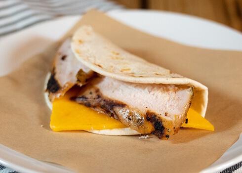 Chicken & Cheese Taco · Slow smoked marinated chicken, cheddar cheese on a flour tortilla