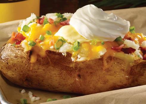 Loaded Giant Baker · A big ole spud filled with your favorite toppings of bacon, cheddar, onions, margarine and sour cream