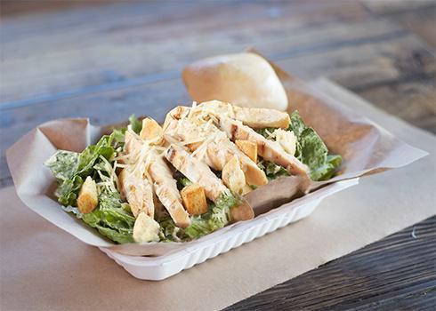 Chicken Caesar Salad · Crisp romaine lettuce, parmesan cheese and crisp croutons top with Marinated smoke chicken.  Includes a warm yeast roll