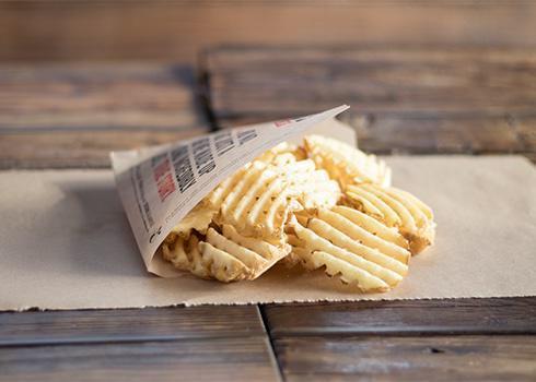 Waffle Fries · Crisp crinkle cut fries dusted with our signature seasoning mix