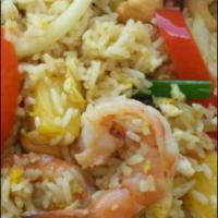 69. Pineapple Fried Rice · Fried rice with chicken and prawns, pineapple, onions, tomatoes, green peas, cashew nuts, ra...