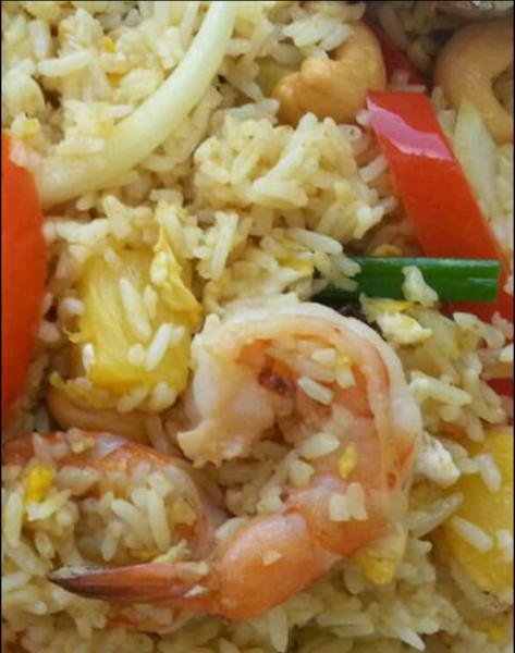 69. Pineapple Fried Rice · Fried rice with chicken and prawns, pineapple, onions, tomatoes, green peas, cashew nuts, raisins and egg.