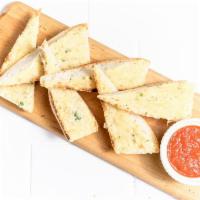 Parmesan Bread · Rustic baguette toasted with herb-garlic butter and Parmesan, side of marinara sauce.