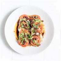 Caprese Salad · Fresh mozzarella, Roma and sun-dried tomatoes, fresh basil, Kalamata olives, olive oil and b...