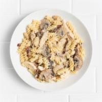 Fusilli alla Roma · Chicken, sun-dried tomatoes, mushrooms, roasted garlic, Parmesan cream sauce, grated Parmesan.
