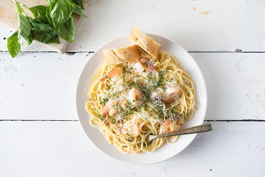 Linguini with Shrimp Scampi · Light and flavorful with a zesty kick of lemon. Tender shrimp sautéed with butter, garlic, lemon and sherry, finished with fresh organic basil and parmesan.