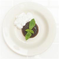 Chocolate Tartufo · Warm triple chocolate cake with a chocolate truffle center, served with whipped cream. 