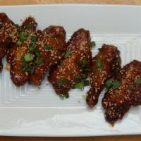 Sweet Chili Wings · Chicken wings, sweet chili glaze, sesame, scallions.
