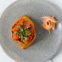 Poke Bomb Korean Ahi · inari sweet-soy pocket, seasoned sushi rice, yellowfin tuna, gochujang, soy glaze, kimchi, o...