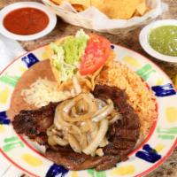 MP Beef Steak a la Tampiquena · 8 oz. ribeye steak topped with grilled onions. Served with Mexican rice, refried beans and g...