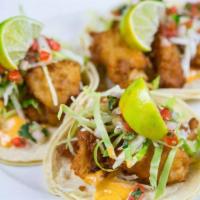 Dos Equis (XX) Fish Tacos · Dos Equis (XX) beer-battered, wild caught haddock, wrapped in a 7-in. tortilla, filled with ...