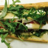 Pesto Baguette · House made pesto, fresh mozzarella, tomato, organic baby spinach honey dijon on grilled baqu...